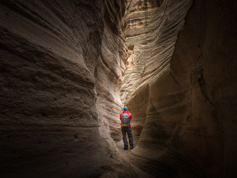 Michael Clark navigating a narrow path in Kasha-Katuwe Tent Rocks National Monument near Chochiti, New Mexico.